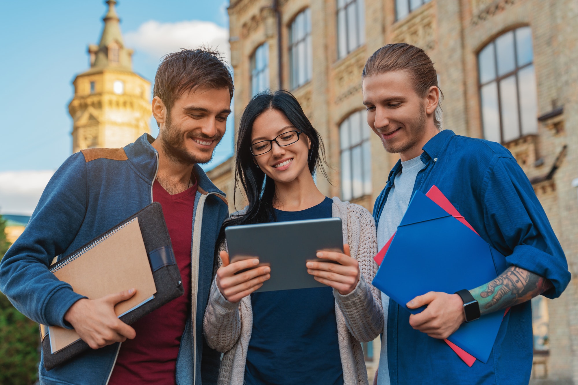 a-group-of-young-multi-ethnic-group-of-student-in-university-smiling-and-looking-at-the-tablet.jpg a-group-of-young-multi-ethnic-group-of-student-in-university-smiling-and-looking-at-the-tablet.jpg